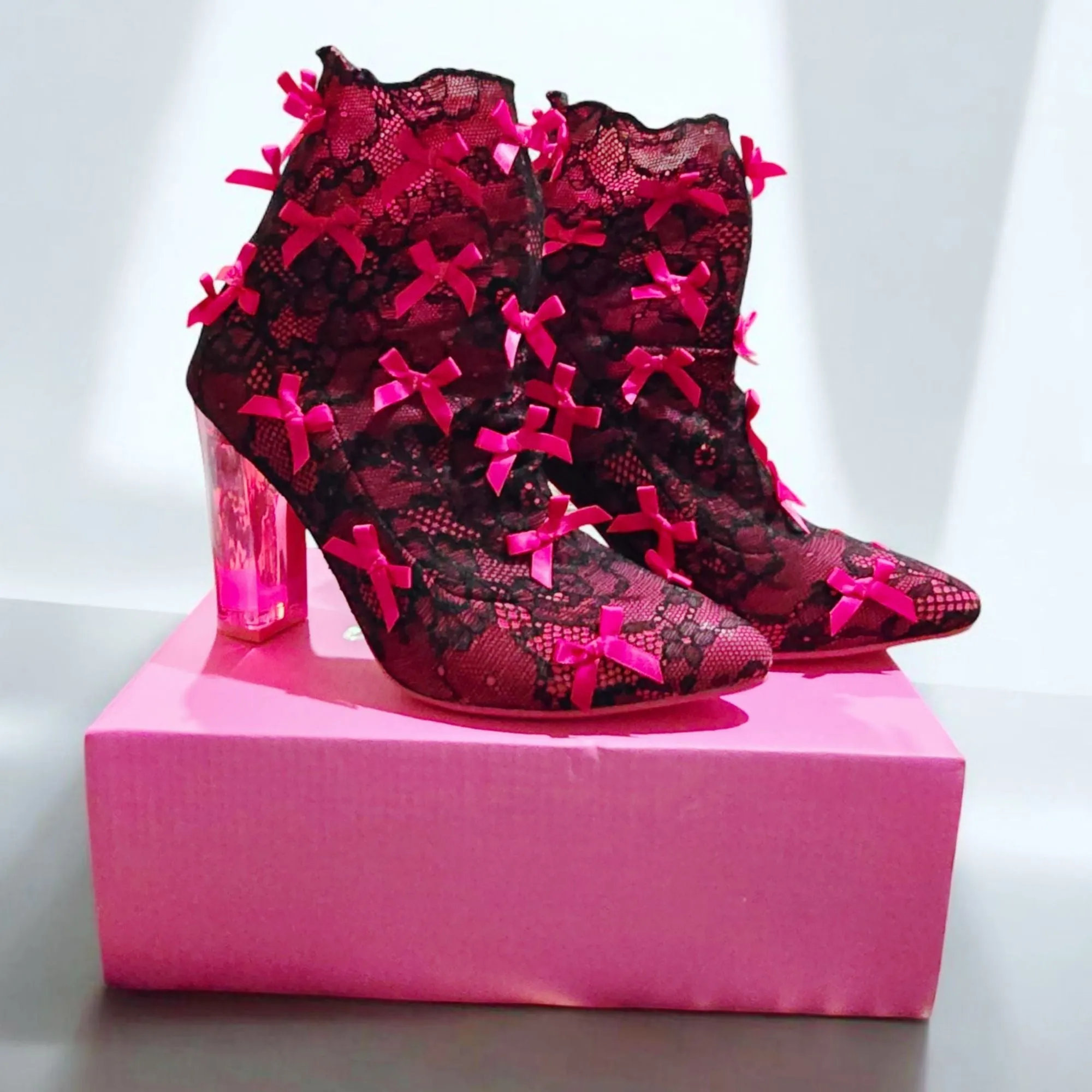 Rubina Portrait Mode Booties W/ Transparent Heel & Bow Accents