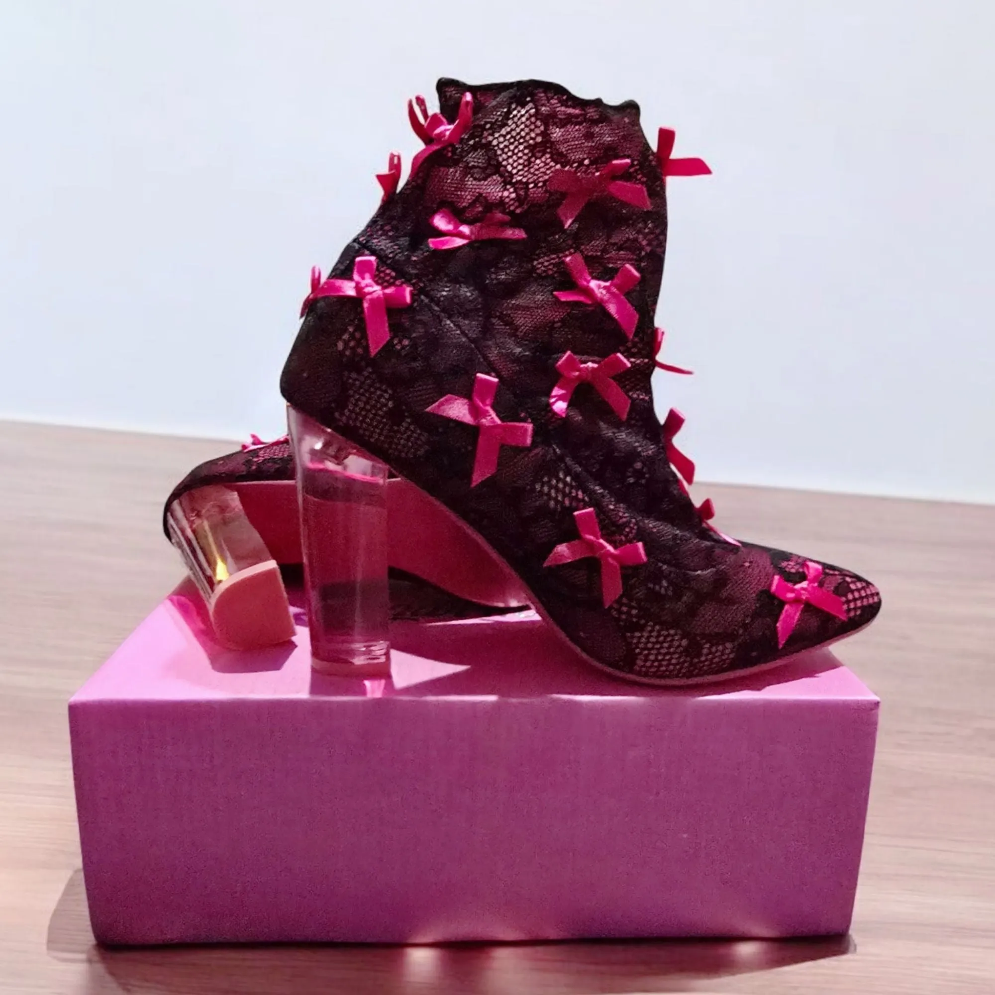 Rubina Portrait Mode Booties W/ Transparent Heel & Bow Accents